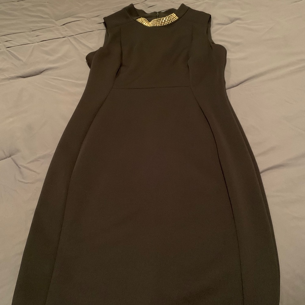 Calvin Klein black dress with gold neck detail.